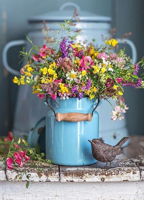 can with flowers and a bird photo postcard