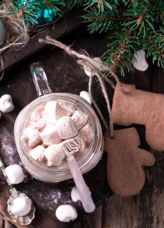 cocoa with marshmallows against a backdrop of Christmas decorations postcards